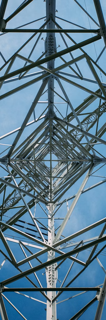 Low-angle transmission tower against blue sky, paired with lime accent panel